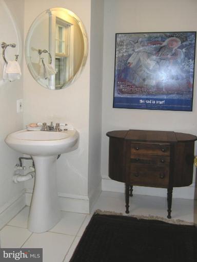 8605 Mayfair Place Silver Spring, MD 20910 - Photo 22 of 23 a bathroom with a sink a mirror and a toilet