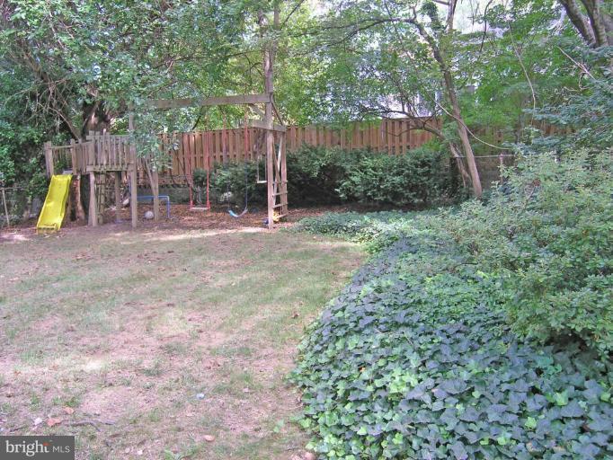 8605 Mayfair Place Silver Spring, MD 20910 - Photo 7 of 23 a view of a backyard with plants and wooden fence