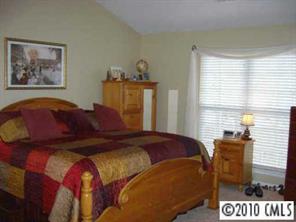 3716 Leela Palace Way Fort Mill, SC 29708 - Photo 5 of 8 a bedroom with a bed and a painting on the wall