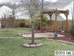 3716 Leela Palace Way Fort Mill, SC 29708 - Photo 7 of 8 a swimming pool with a bench and trees