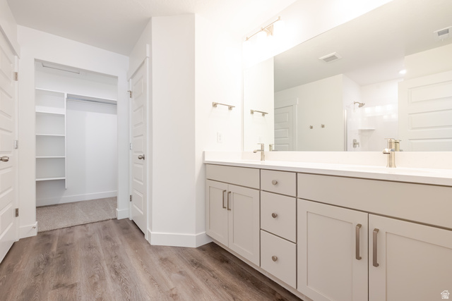 5287 South Acacia Drive, Unit 714 Mapleton, UT 84664 - Photo 15 of 21 Bathroom vanity featuring dual undermount sinks with brushed nickel faucets, a large mirror, and light gray cabinetry with brushed nickel hardware