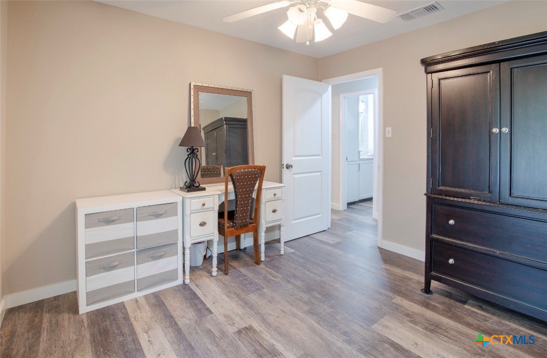 188 Cavalry Road Victoria, TX 77905 - Photo 7 of 30 a view of a hallway with wooden floor and furniture