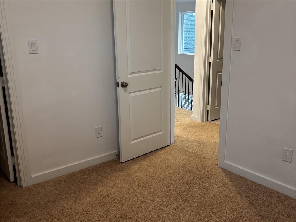 2828 Walden Road Celina, TX 75009 - Photo 17 of 30 Light-colored walls, brown carpeting, and a white interior door with a brushed nickel knob