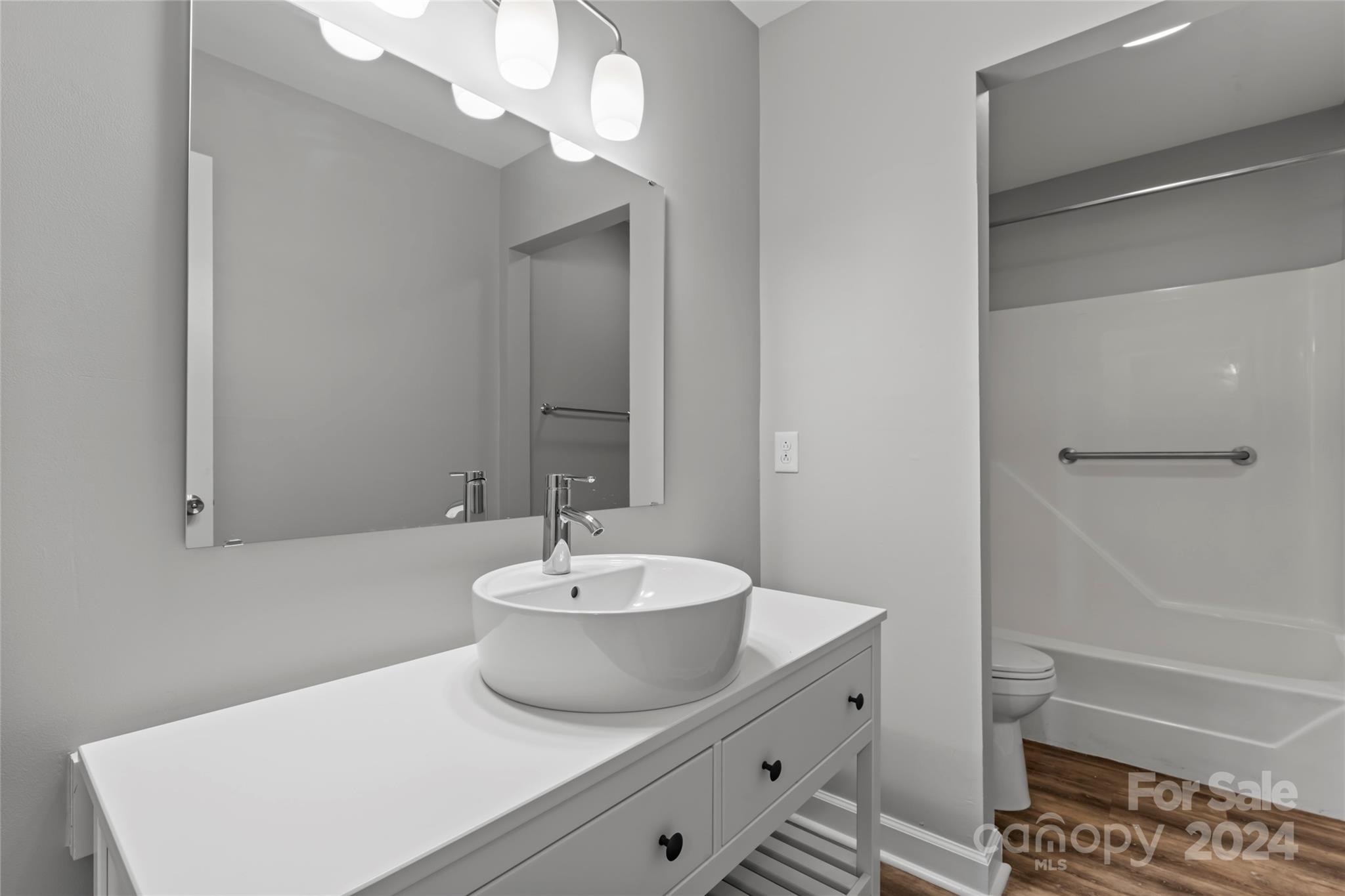 7035 Quail Hill Road Charlotte, NC 28210 - Photo 14 of 40 a bathroom with a sink a toilet and shower
