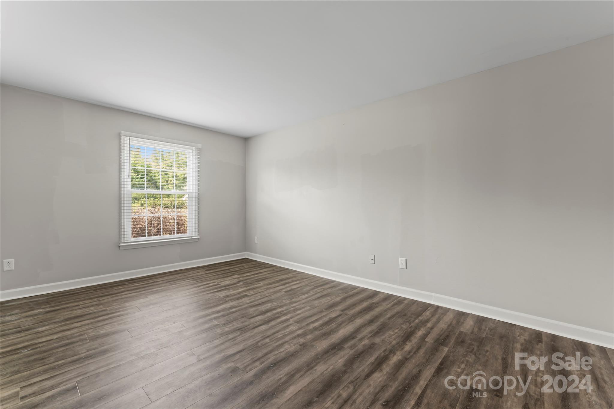 7035 Quail Hill Road Charlotte, NC 28210 - Photo 17 of 40 a view of an empty room with wooden floor and a window