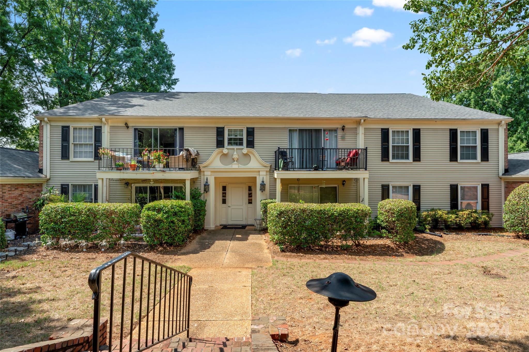 7035 Quail Hill Road Charlotte, NC 28210 - Photo 2 of 40 a front view of a house with a yard and potted plants