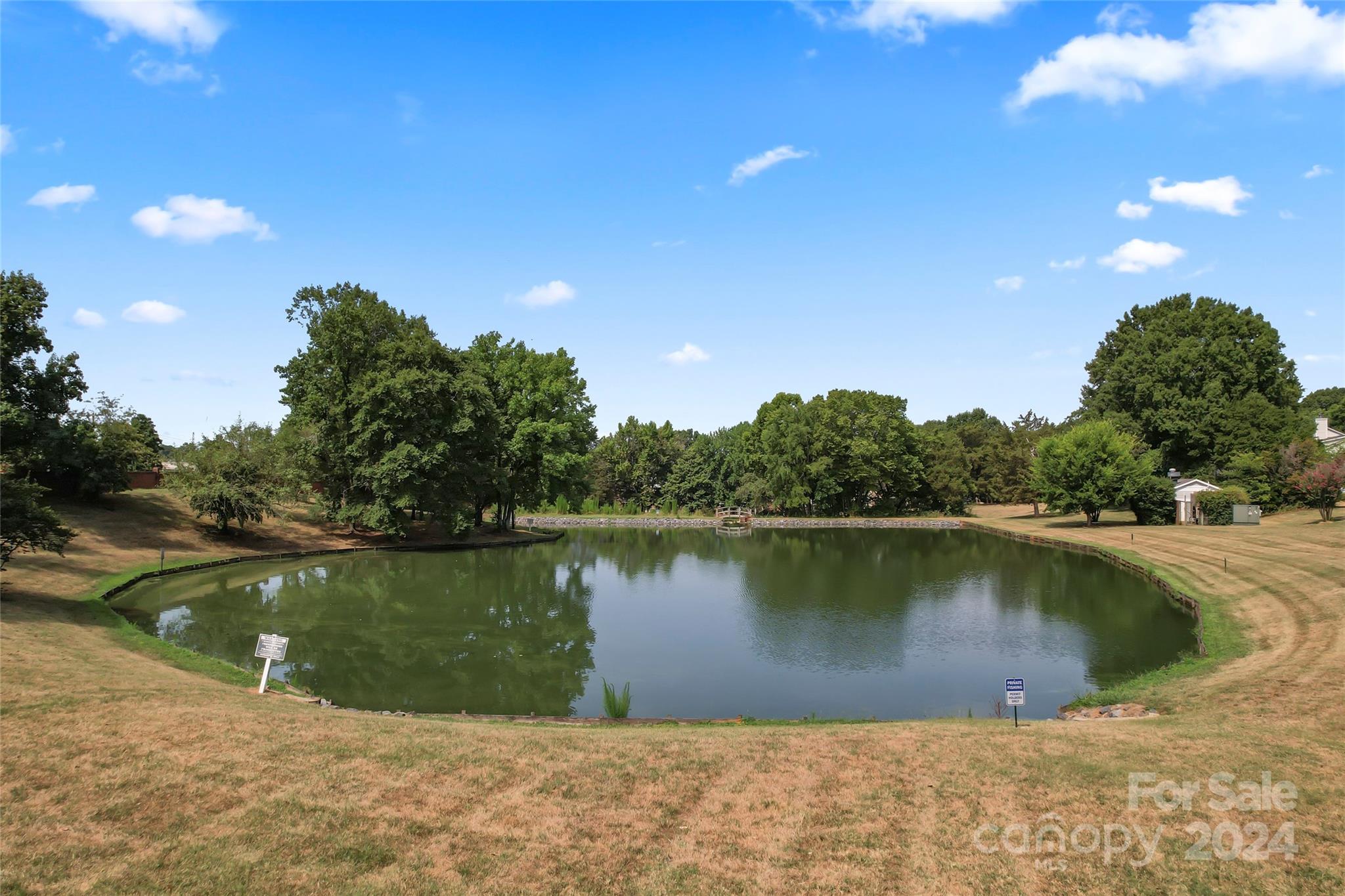 7035 Quail Hill Road Charlotte, NC 28210 - Photo 40 of 40 a view of a lake with a yard and a wooden fence