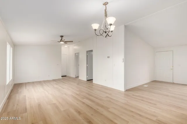 a view of a livingroom with furniture a ceiling fan and window