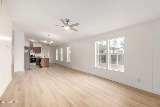 a view of a kitchen with a sink dishwasher a refrigerator and wooden floor