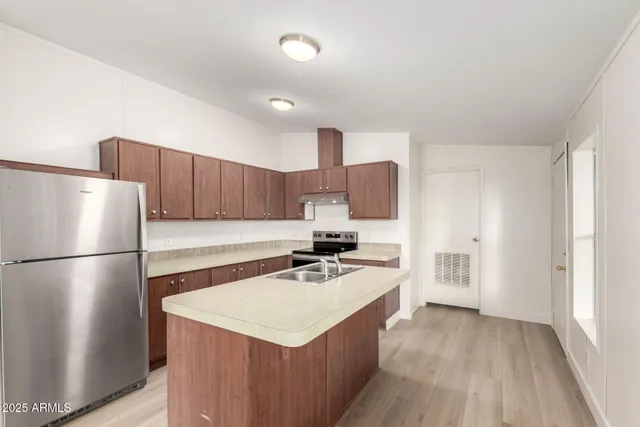 a kitchen with a stove sink and cabinets