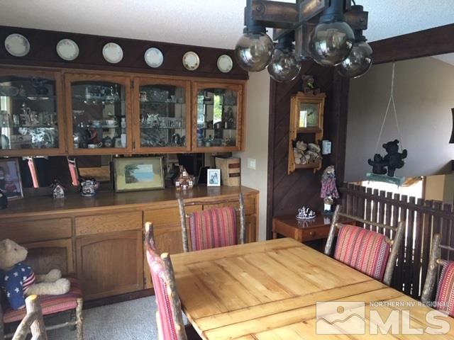 14620 Rim Rock Drive Reno, NV 89521 - Photo 5 of 23 a bedroom with a bed a chandelier and dresser