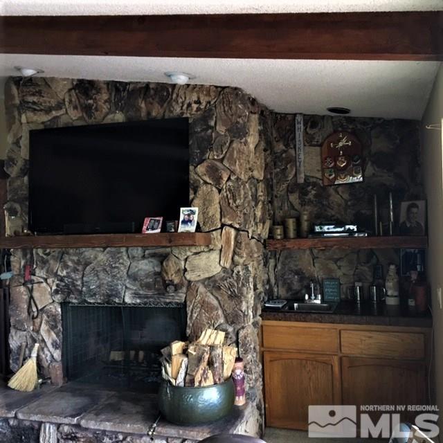 14620 Rim Rock Drive Reno, NV 89521 - Photo 7 of 23 a room with fireplace and lots of racks