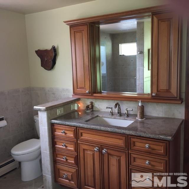 14620 Rim Rock Drive Reno, NV 89521 - Photo 8 of 23 a bathroom with a granite countertop toilet sink and mirror