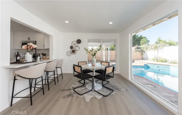 a view of a dining room with furniture a chandelier and wooden floor