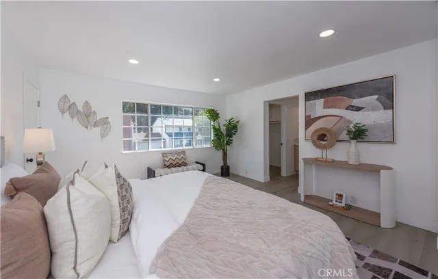 a bedroom with a bed and a window