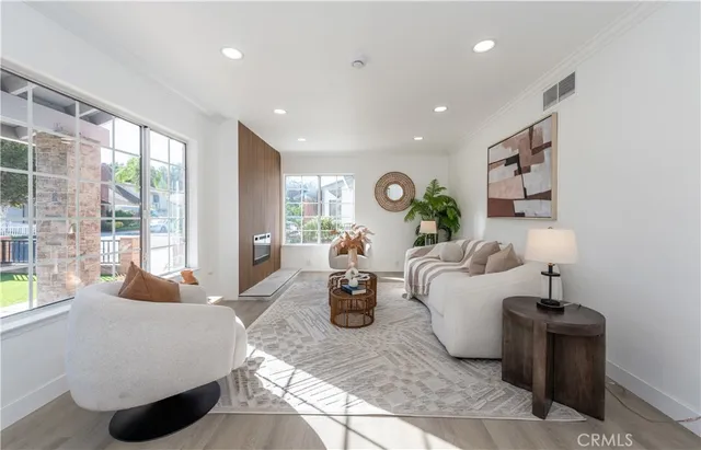 a living room with furniture and large windows