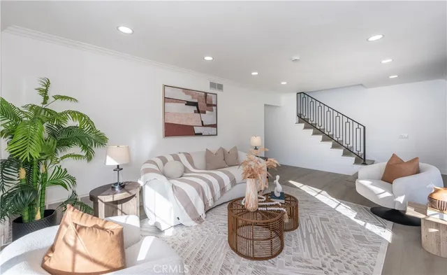 a living room with furniture and a potted plant