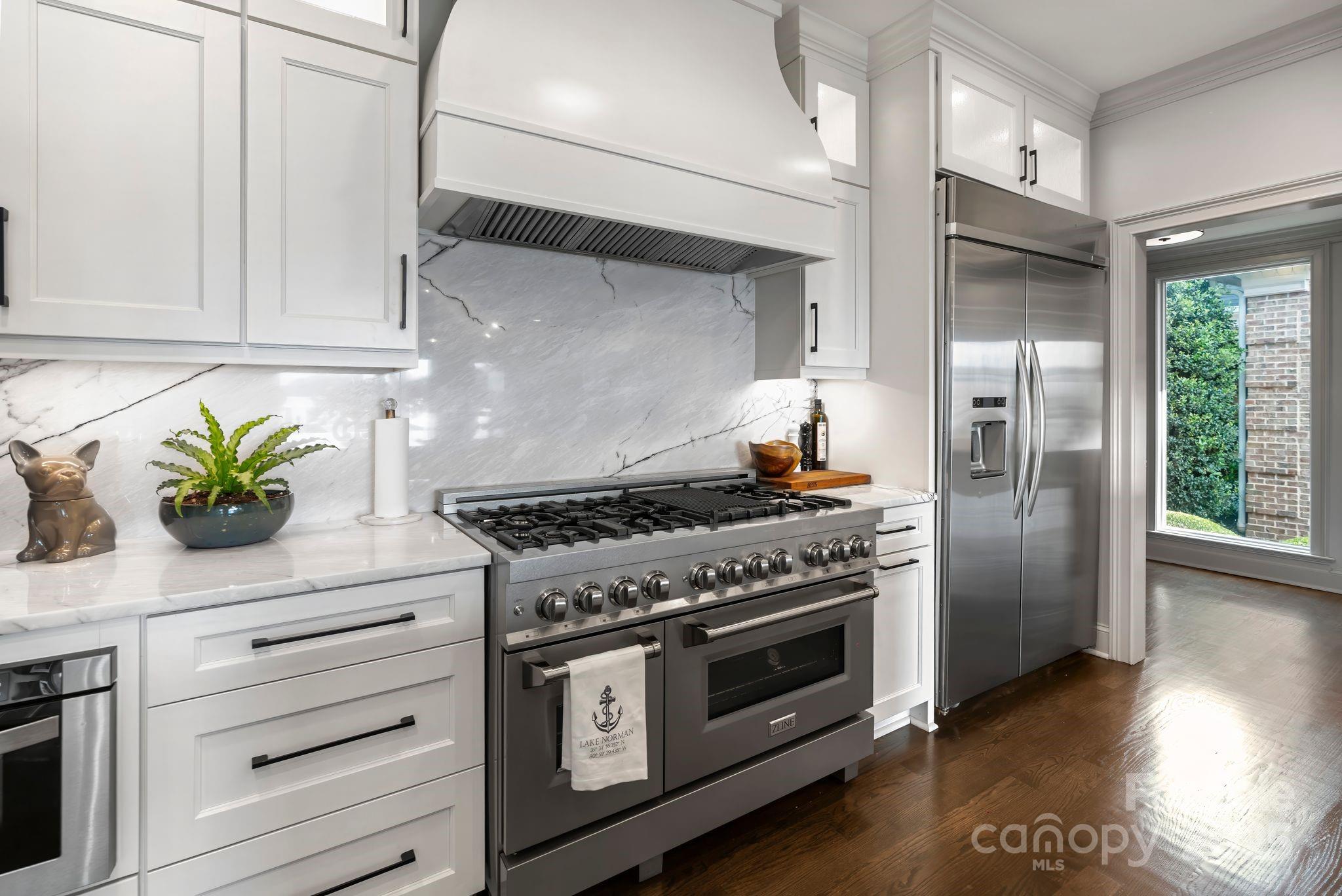 17819 John Connor Road Cornelius, NC 28031 - Photo 11 of 48 a kitchen with stainless steel appliances white cabinets and a stove