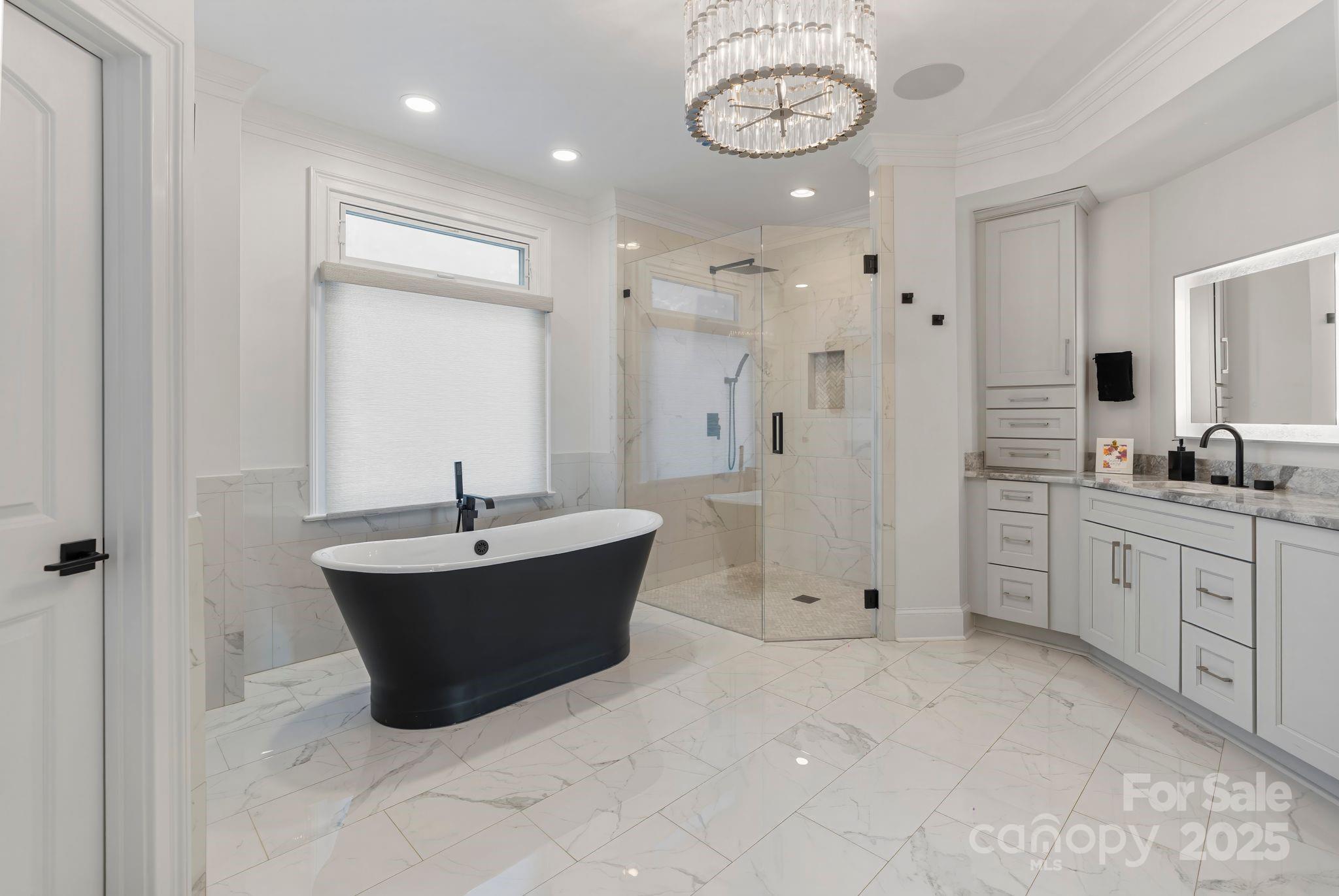 17819 John Connor Road Cornelius, NC 28031 - Photo 20 of 48 a spacious bathroom with a tub sink and mirror