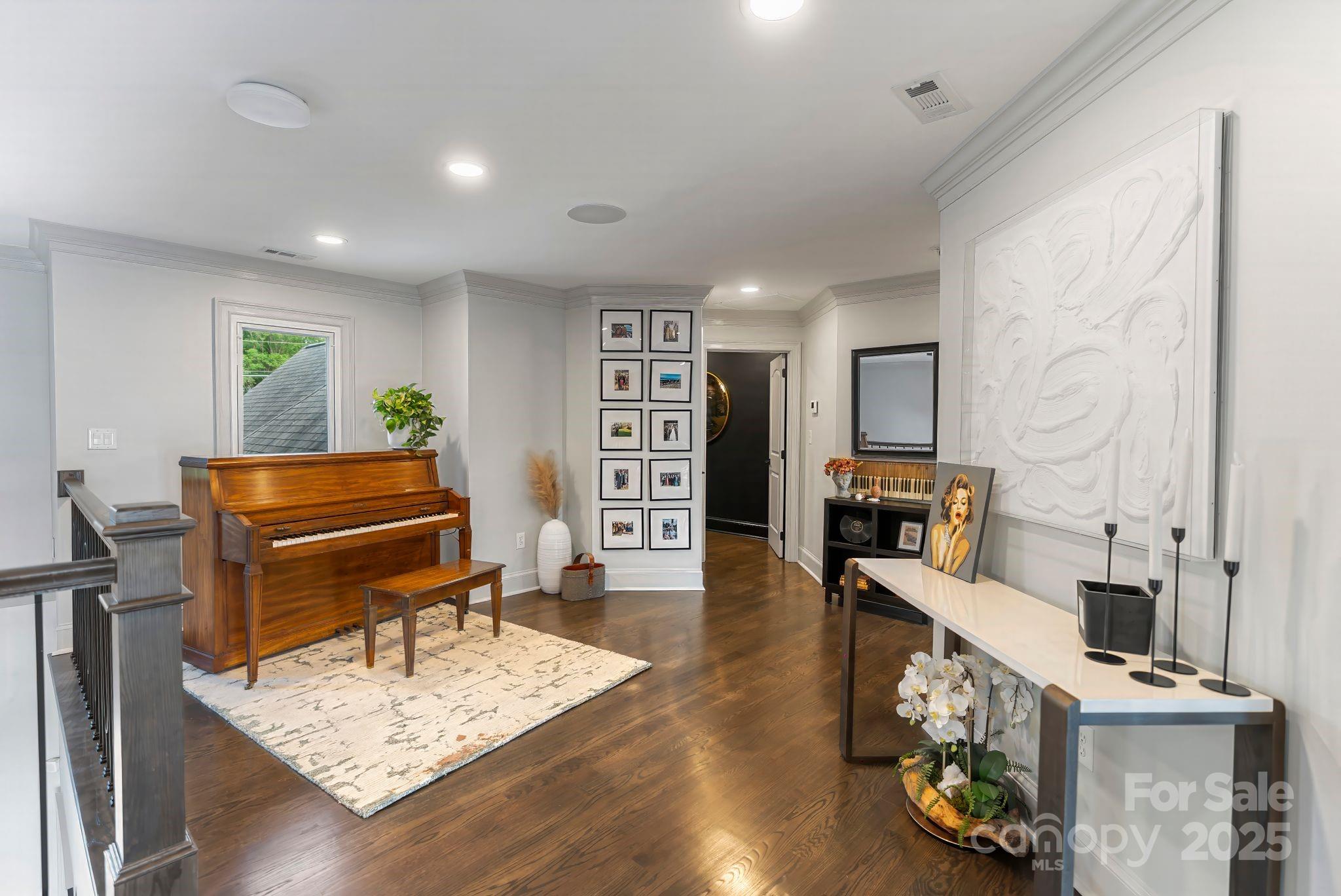 17819 John Connor Road Cornelius, NC 28031 - Photo 23 of 48 a living room with furniture a piano and a bookshelf