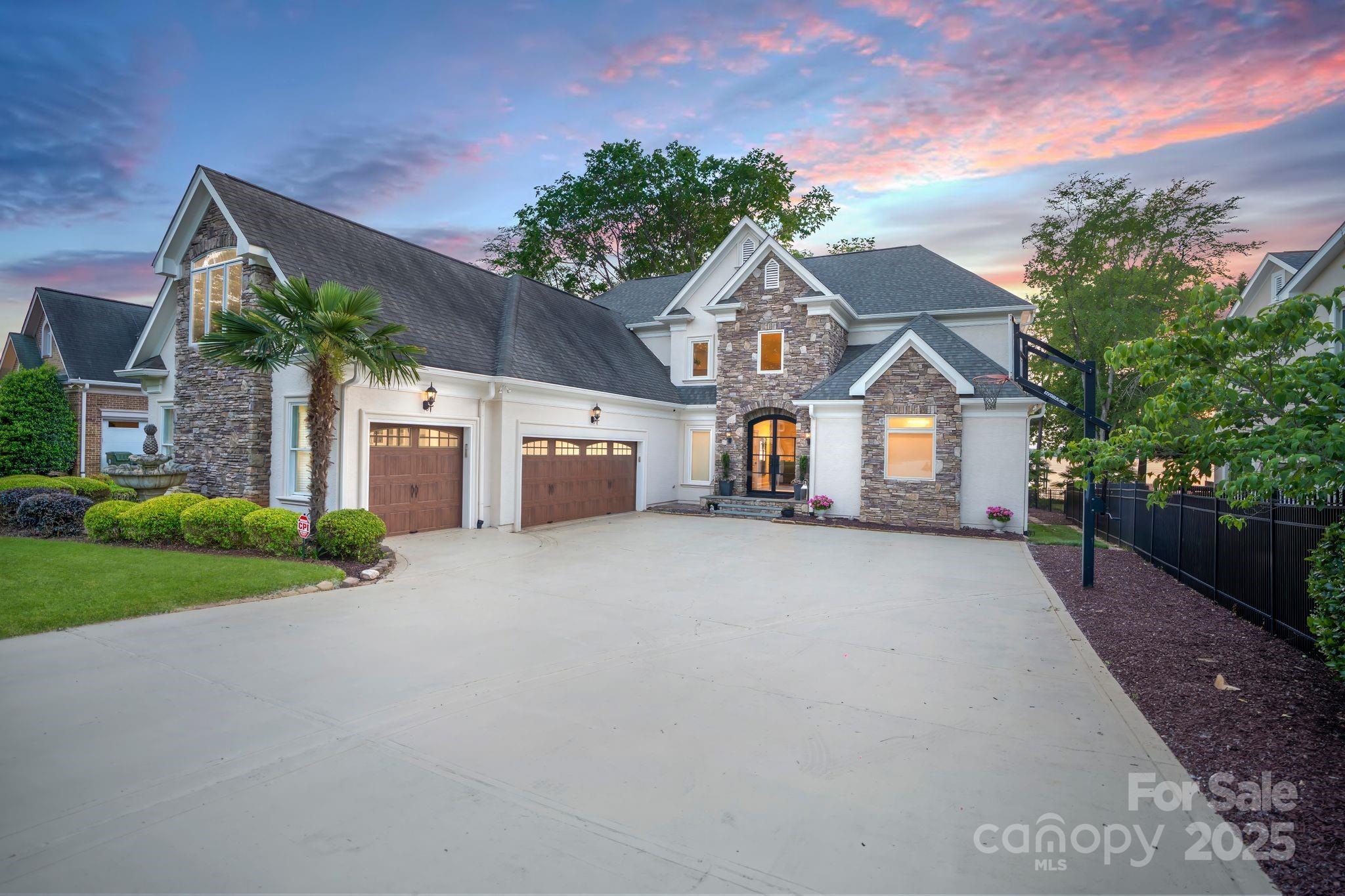 17819 John Connor Road Cornelius, NC 28031 - Photo 3 of 48 a front view of a house with a yard and garage