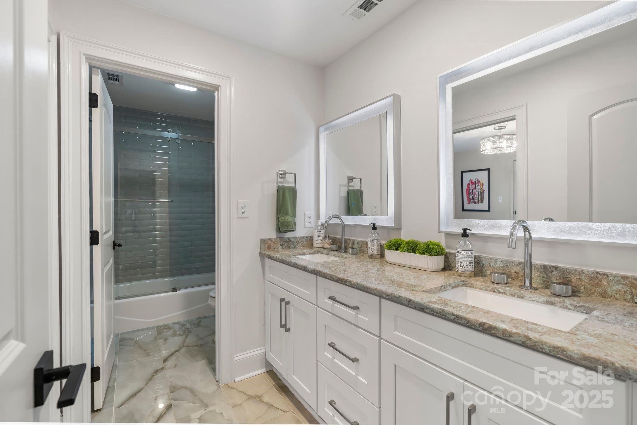 17819 John Connor Road Cornelius, NC 28031 - Photo 31 of 48 a bathroom with double vanity sinks and a shower