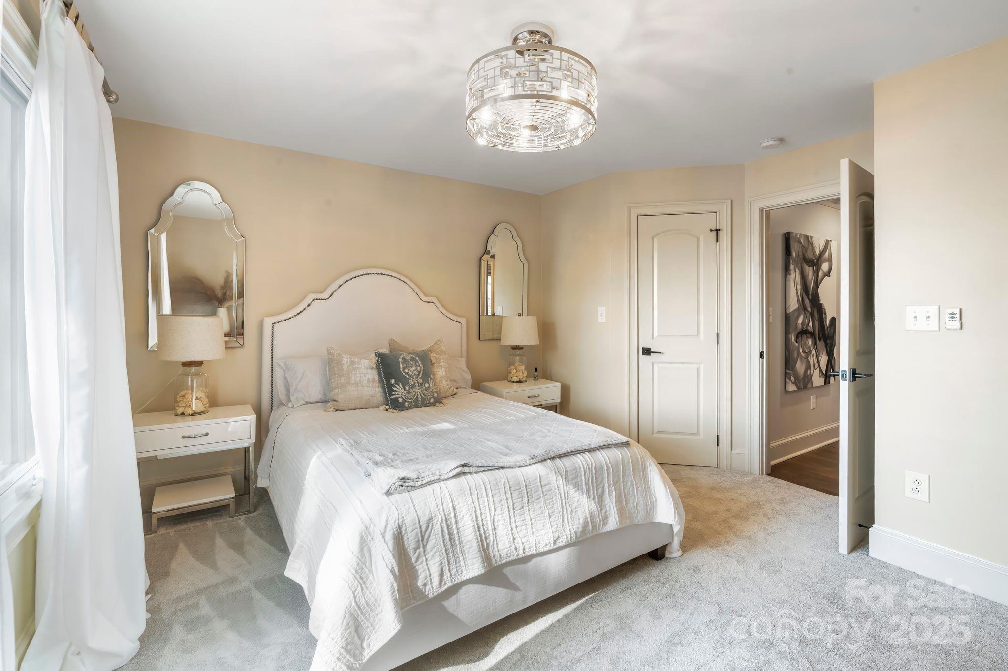 17819 John Connor Road Cornelius, NC 28031 - Photo 33 of 48 a bedroom with bed and a chandelier