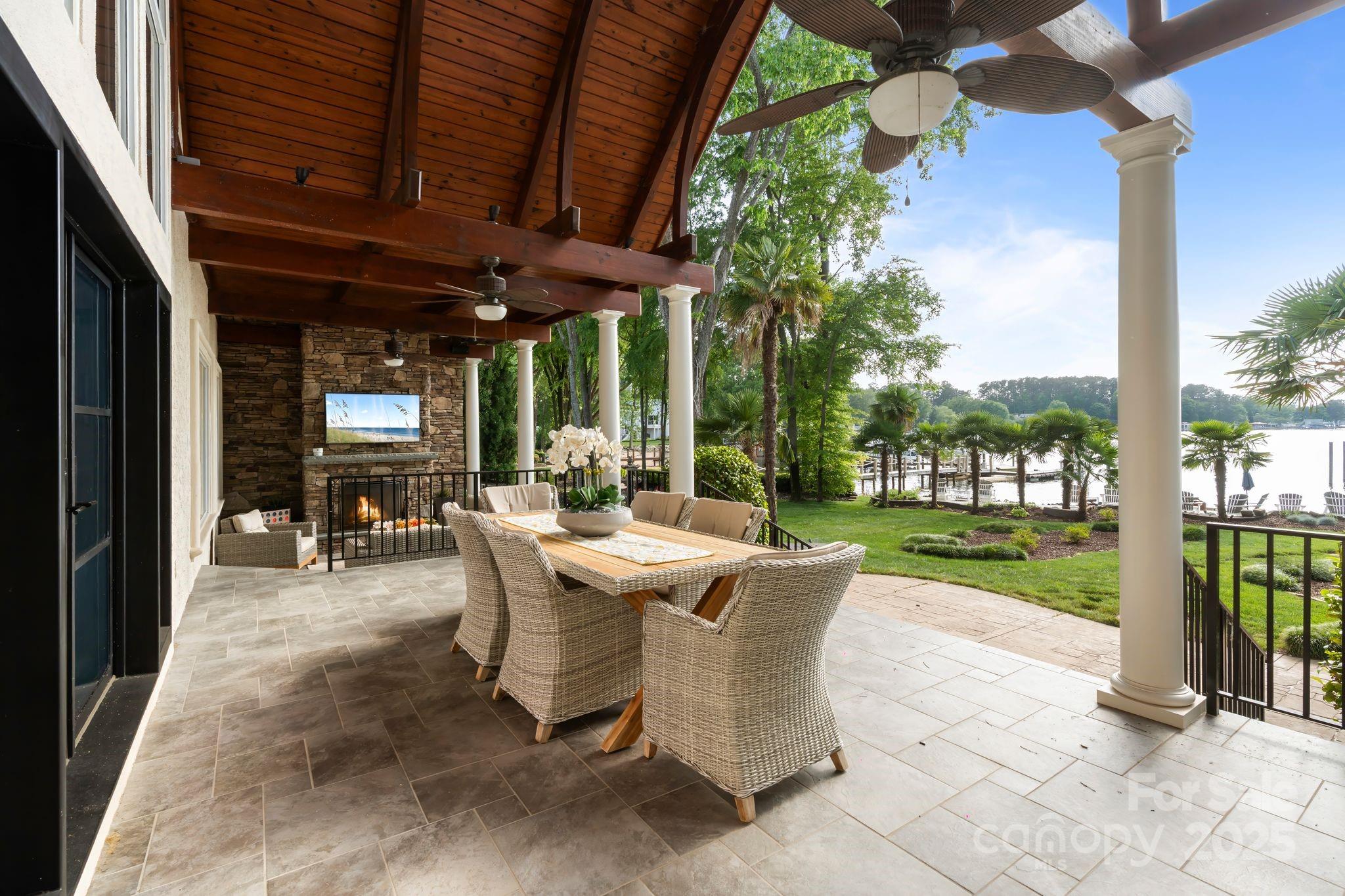 17819 John Connor Road Cornelius, NC 28031 - Photo 36 of 48 a view of a patio with table and chairs potted plants and floor to ceiling window
