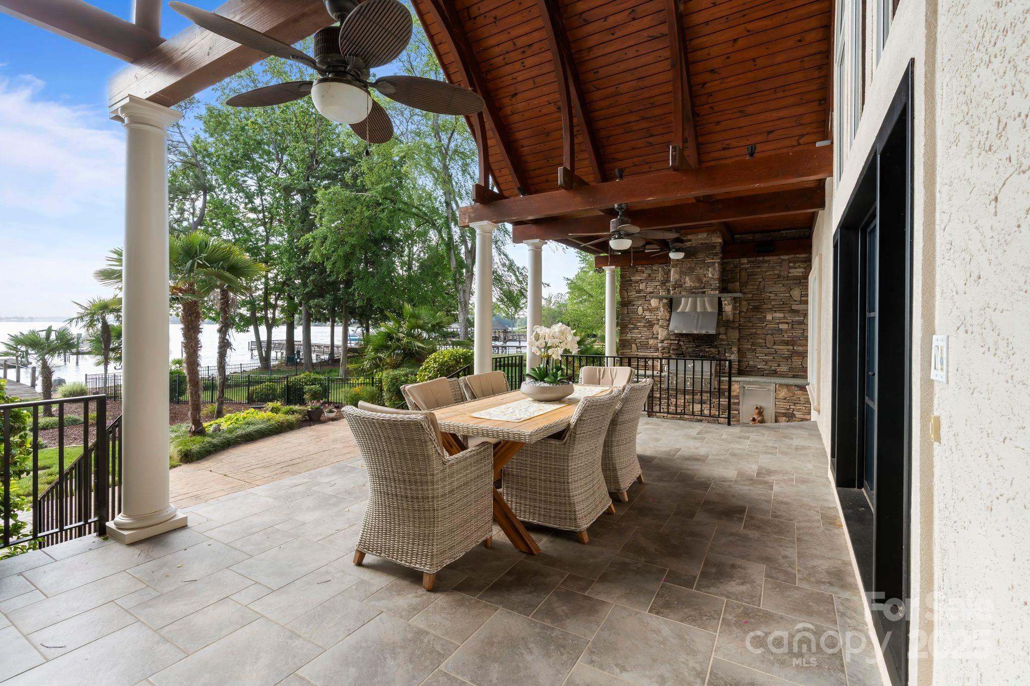 17819 John Connor Road Cornelius, NC 28031 - Photo 38 of 48 a view of a patio with table and chairs potted plants with floor to ceiling window