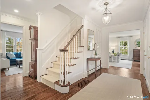 a view of entryway and hall with wooden floor