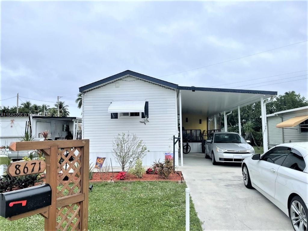 8671 Southwest 18th Place Davie, FL 33324 - Photo 1 of 22 a view of a patio with furniture and a grill