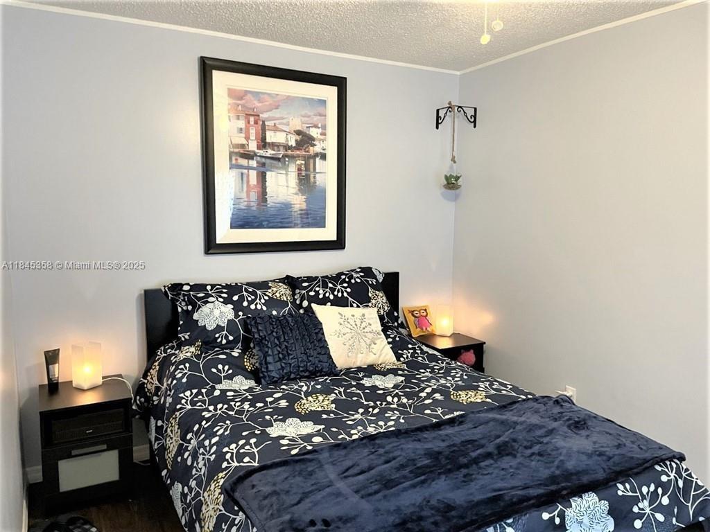 8671 Southwest 18th Place Davie, FL 33324 - Photo 12 of 22 a bed sitting in a bedroom next to a lamp