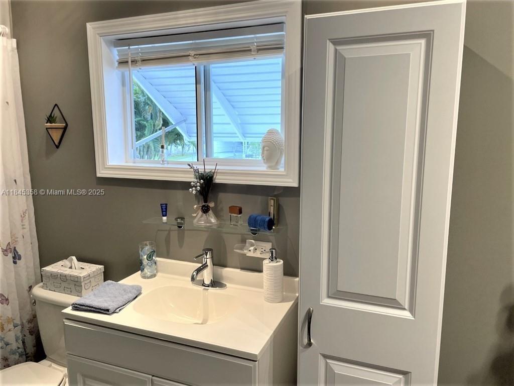 8671 Southwest 18th Place Davie, FL 33324 - Photo 15 of 22 a bathroom with a sink and a mirror