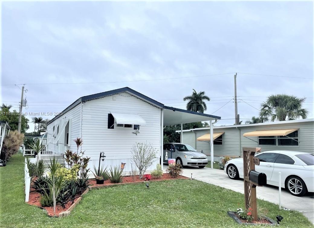 8671 Southwest 18th Place Davie, FL 33324 - Photo 17 of 22 a front view of house with yard and seating area