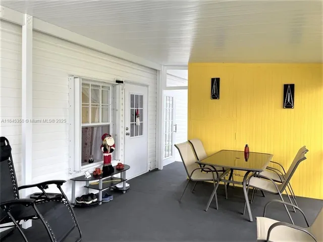 a view of a dining room with furniture and windows