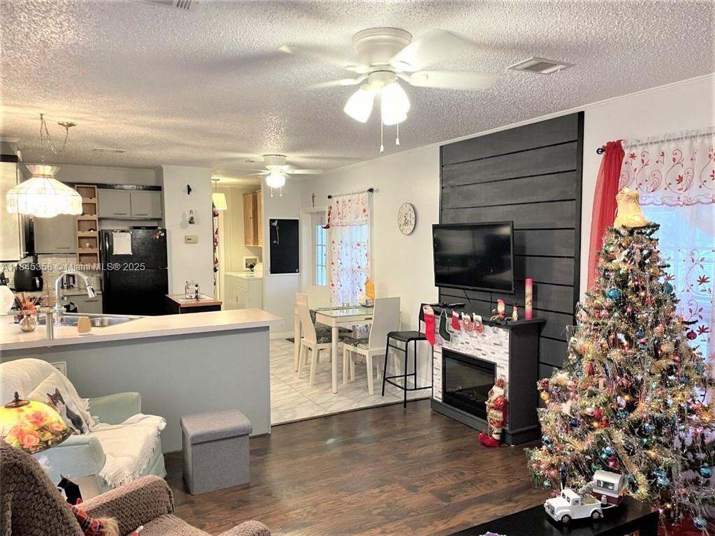 8671 Southwest 18th Place Davie, FL 33324 - Photo 4 of 22 a living room with furniture and a flat screen tv