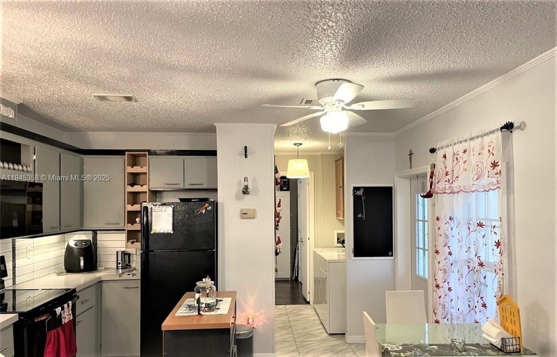 8671 Southwest 18th Place Davie, FL 33324 - Photo 5 of 22 a living room with furniture and a flat screen tv