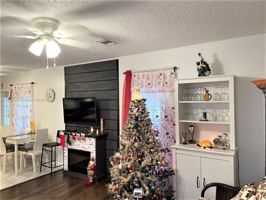 8671 Southwest 18th Place Davie, FL 33324 - Photo 7 of 22 a living room with furniture and a flat screen tv