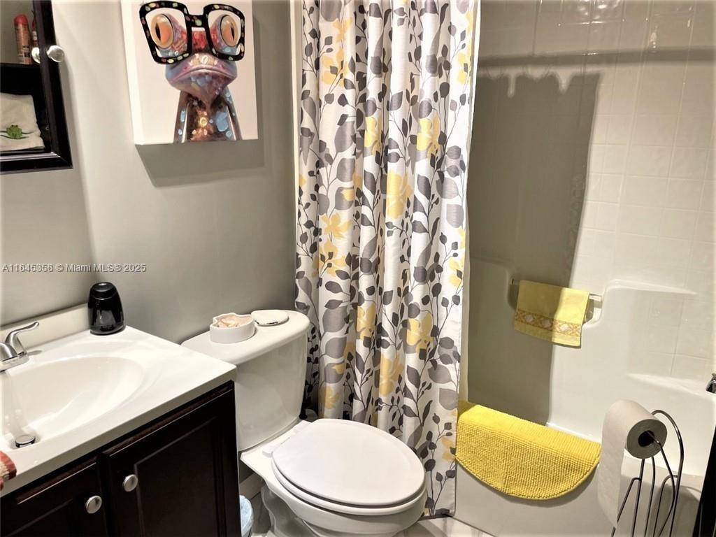 8671 Southwest 18th Place Davie, FL 33324 - Photo 10 of 22 a white toilet sitting next to a bathroom sink