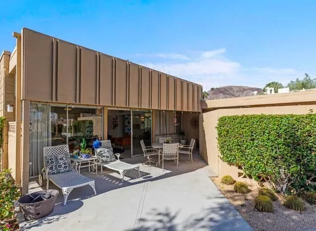 a view of a chairs and table in patio