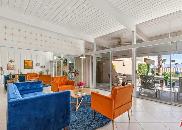 a living room with furniture a table and chairs