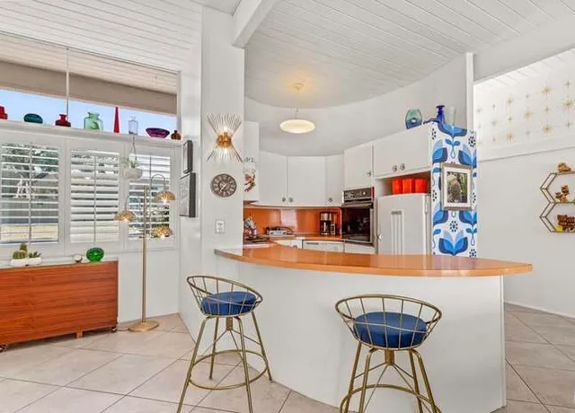 a dining room with furniture and a chandelier