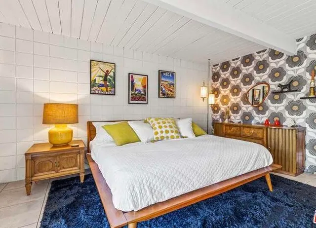 a bedroom with a bed and lamp