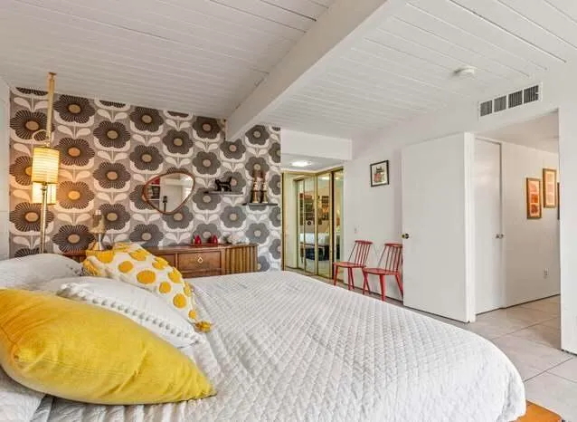 a bedroom with a bed and a chair