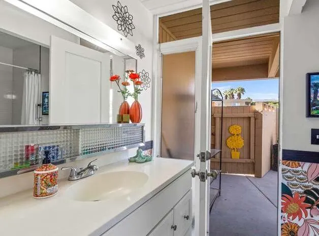 a bathroom with a sink mirror and vanity