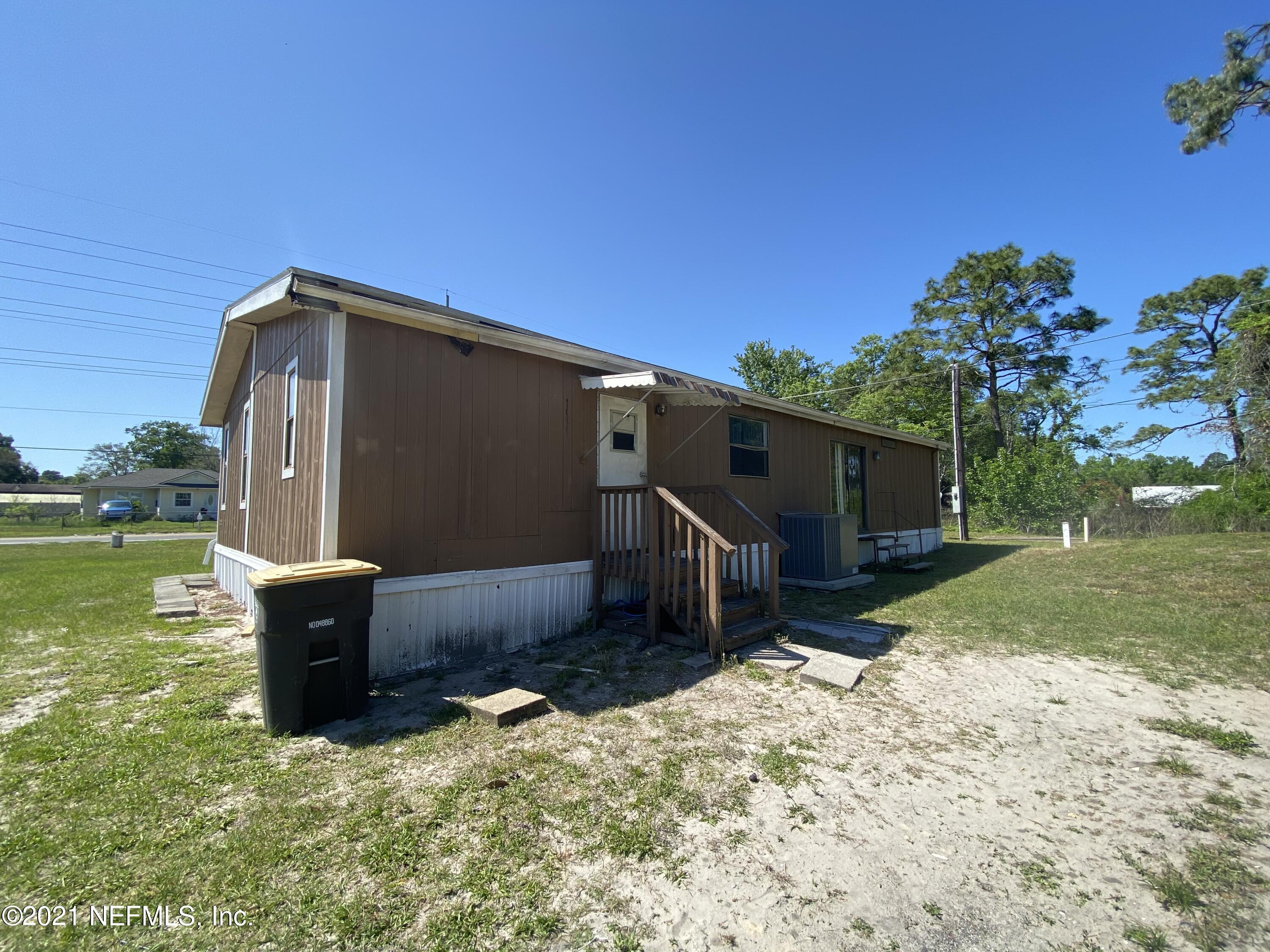 6427 Firestone Road Jacksonville, FL 32244 - Photo 1 of 55 a backyard of a house with lots of green space