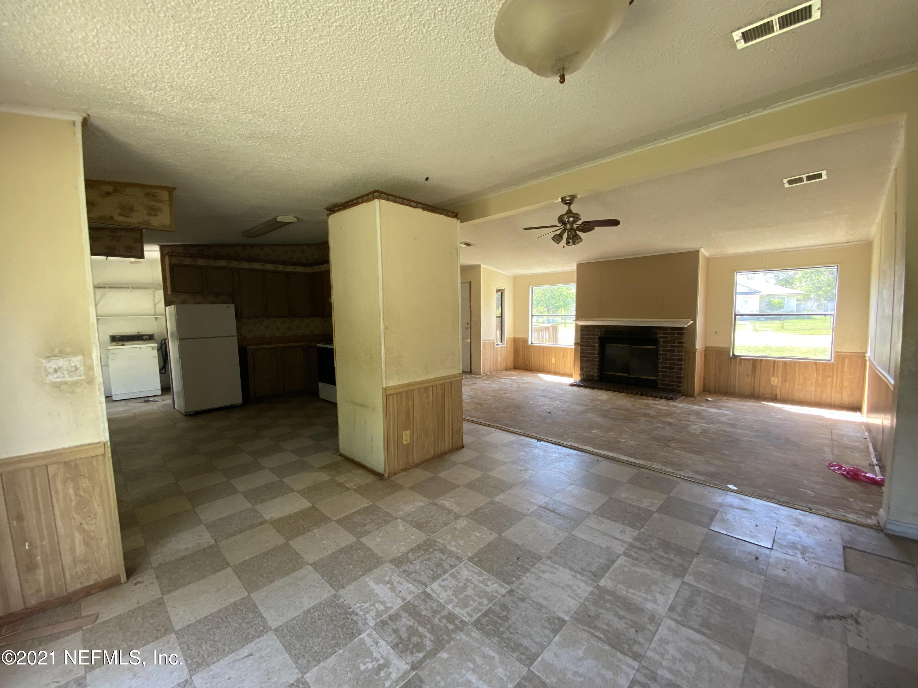 6427 Firestone Road Jacksonville, FL 32244 - Photo 17 of 55 a view of empty room with a fireplace