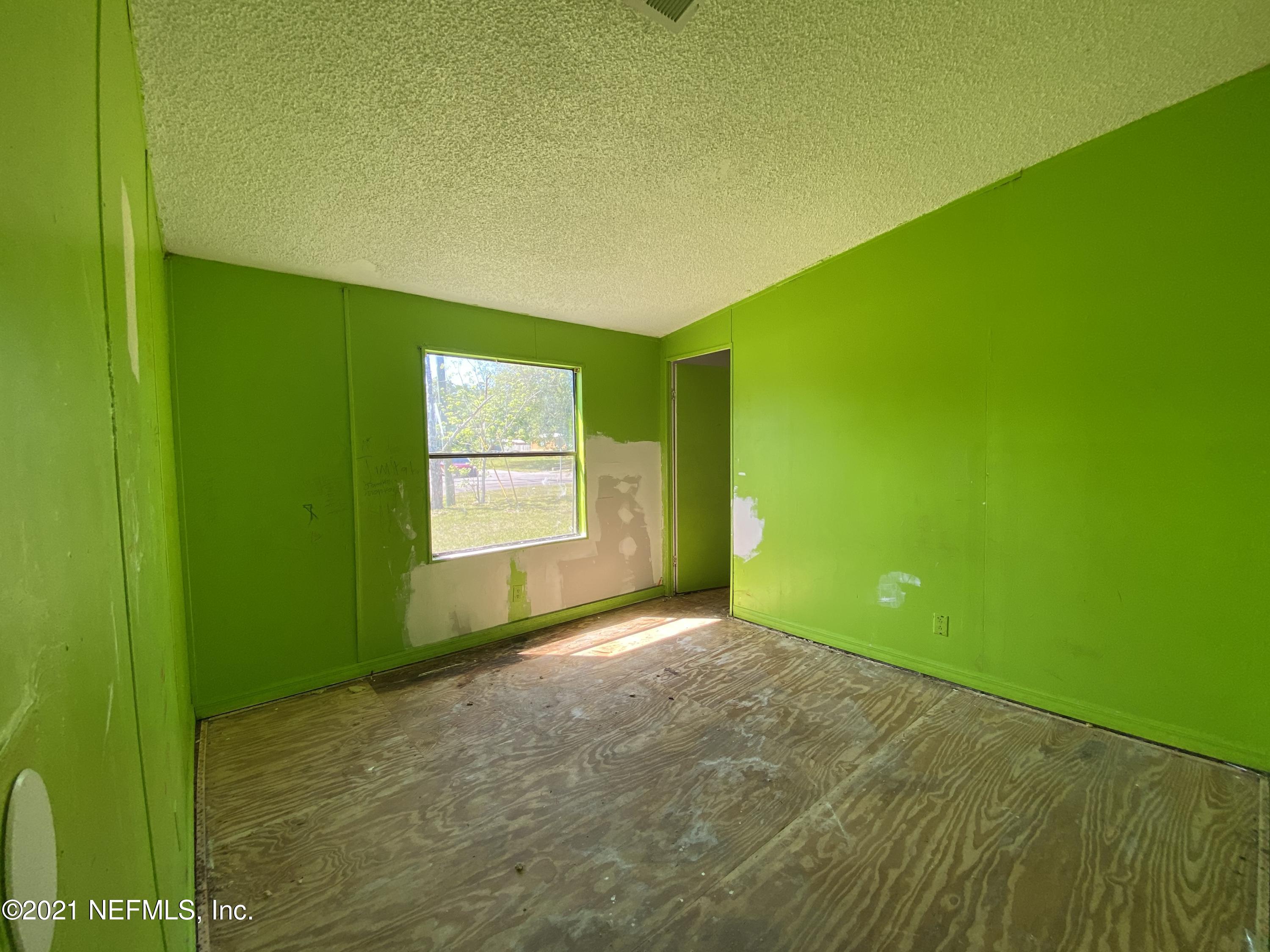 6427 Firestone Road Jacksonville, FL 32244 - Photo 22 of 55 a view of a big room with a big yard