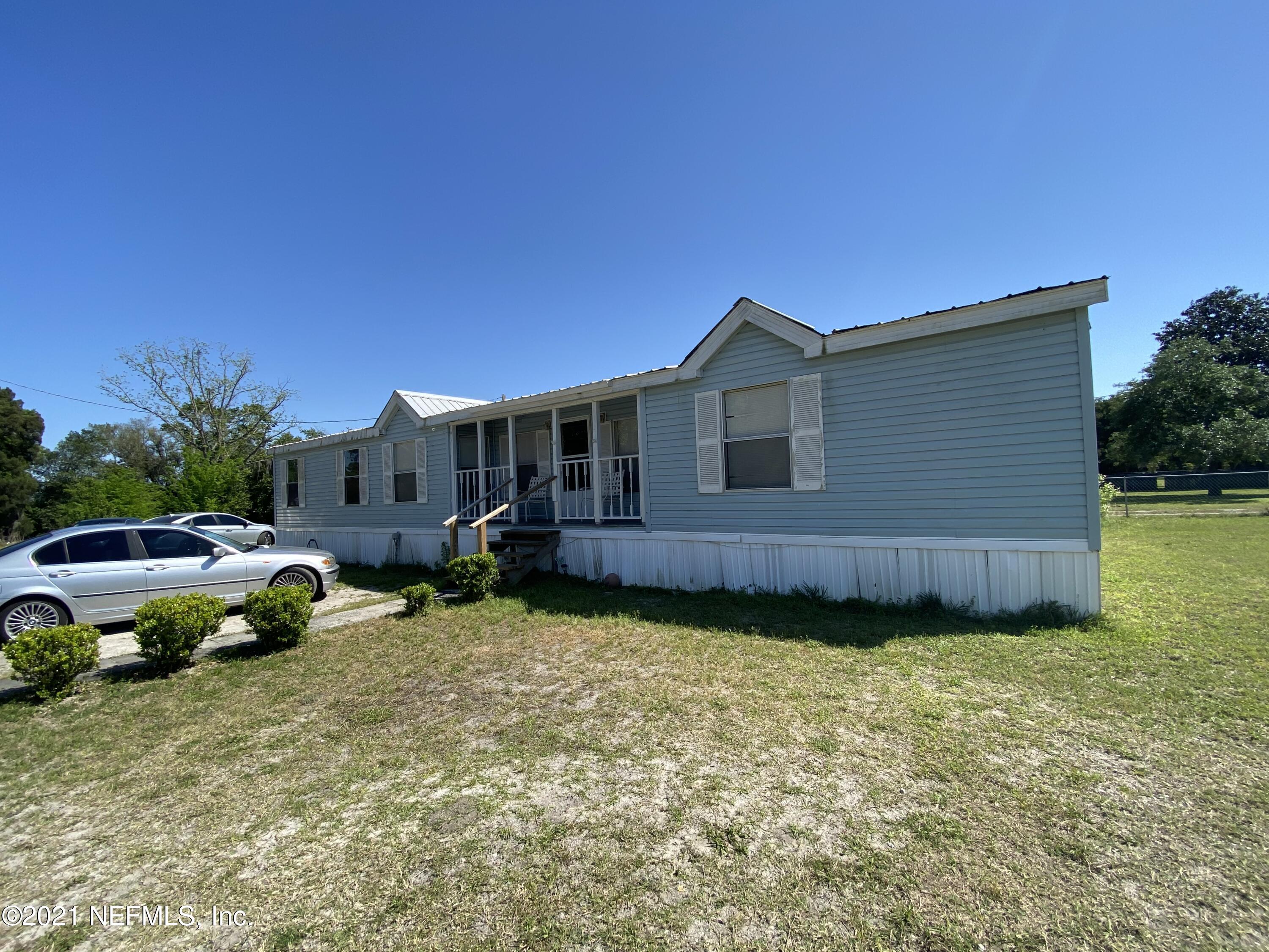6427 Firestone Road Jacksonville, FL 32244 - Photo 26 of 55 a view of a house with backyard and sitting area
