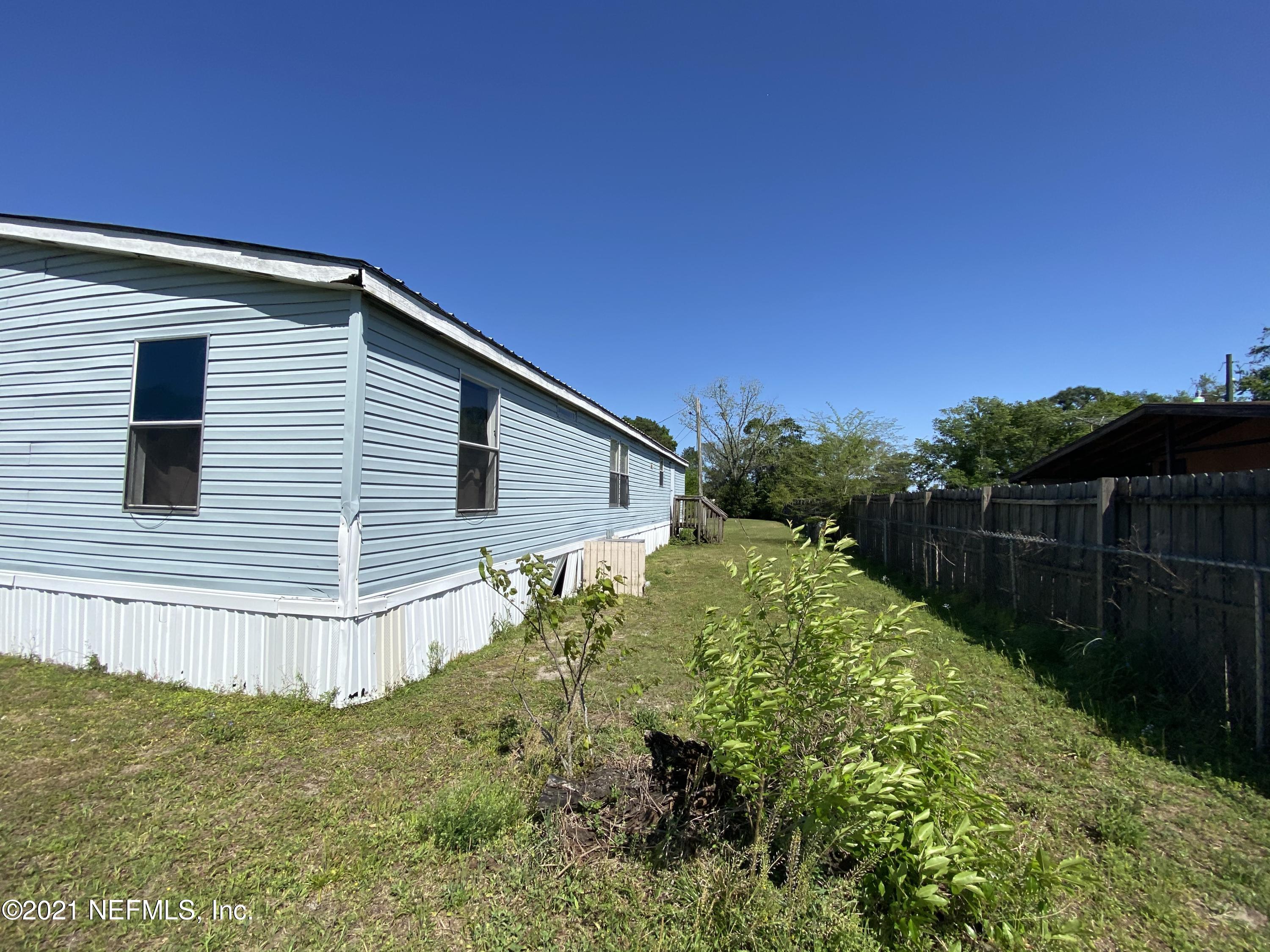 6427 Firestone Road Jacksonville, FL 32244 - Photo 28 of 55 a backyard of a house with lots of green space